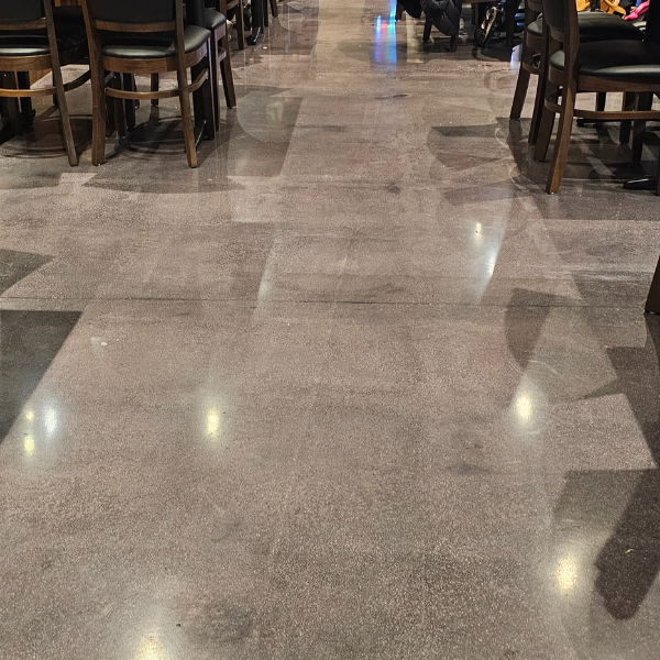 Enhance your space with polished concrete, a durable, glossy flooring solution requiring no additional coatings. Perfect for offices, retail, and warehouses.