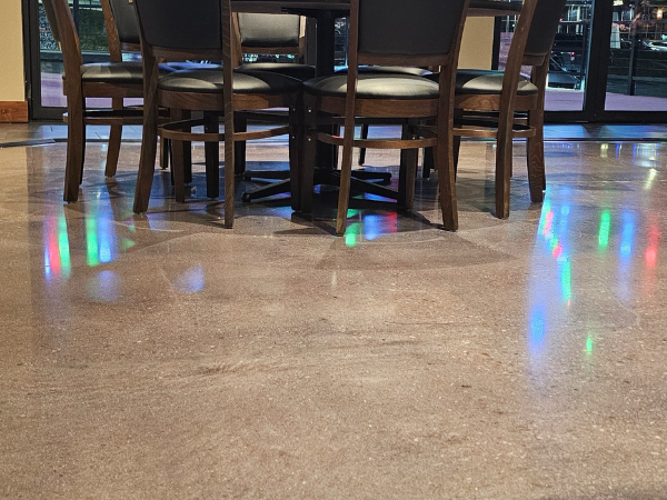 Enhance your space with polished concrete, a durable, glossy flooring solution requiring no additional coatings. Perfect for offices, retail, and warehouses.